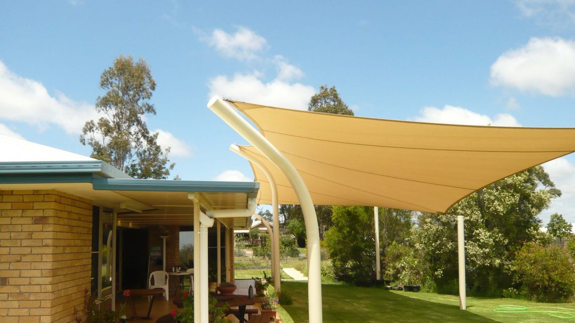 Cream Shade Sail near brick house Residential